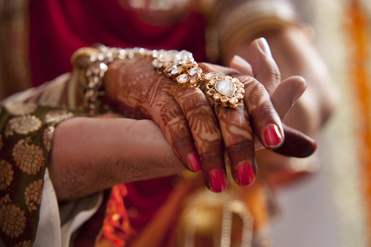 Close-up of hands of groom and bride 