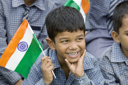 School boy holding the Indian flag 
