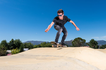 Skateboarder on a pump track park