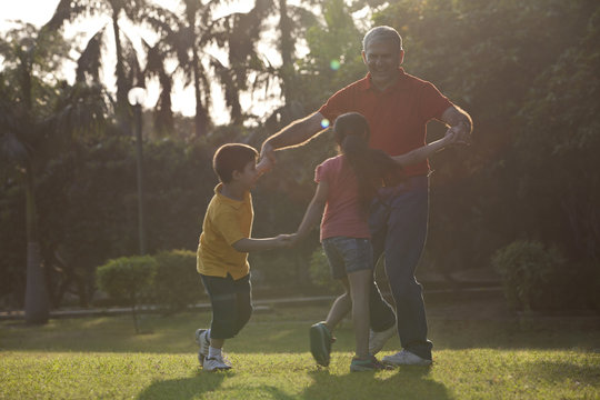Grandfather playing with his grandchildren