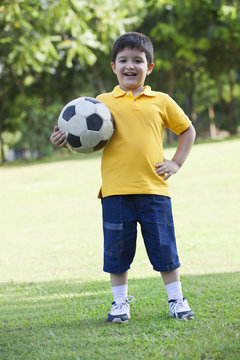 Portrait of a young boy holding a football