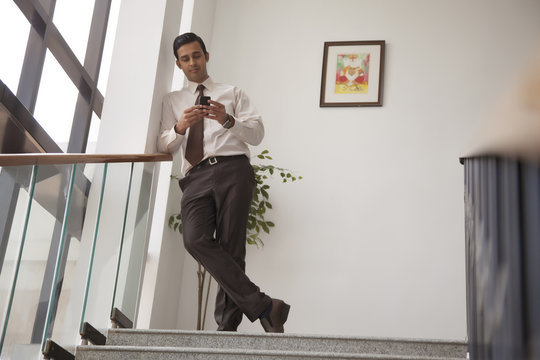 Executive reading an sms on a mobile phone