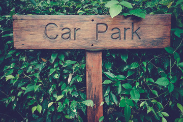 Label Wooden Car Park on Green leaf background