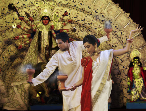 Bengali couple doing a Dhunuchi dance 
