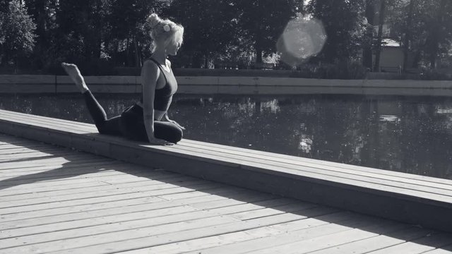 Young woman doing yoga exercises in the park
