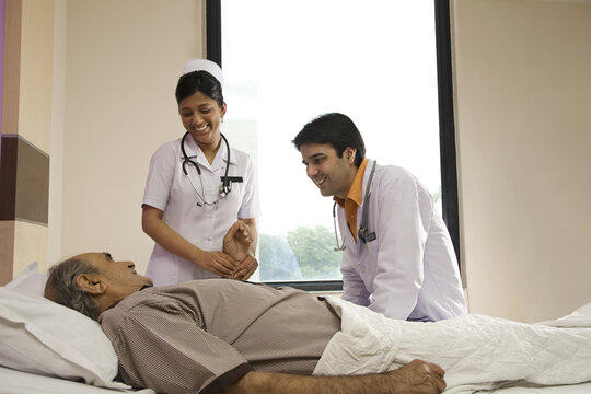 Nurse checking a patient's pulse 