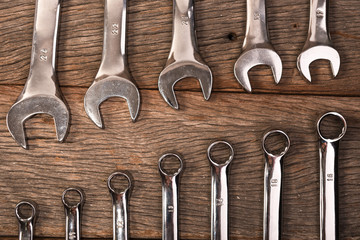 wrenches on wooden background