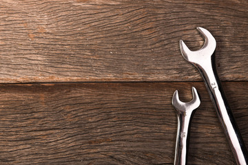 wrenches on wooden background