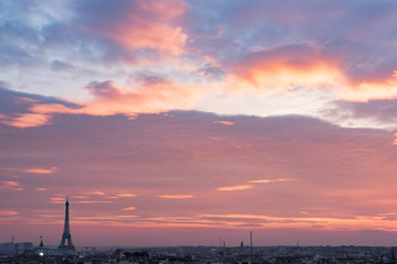 Paris skyline with purple clouds at sunset, France