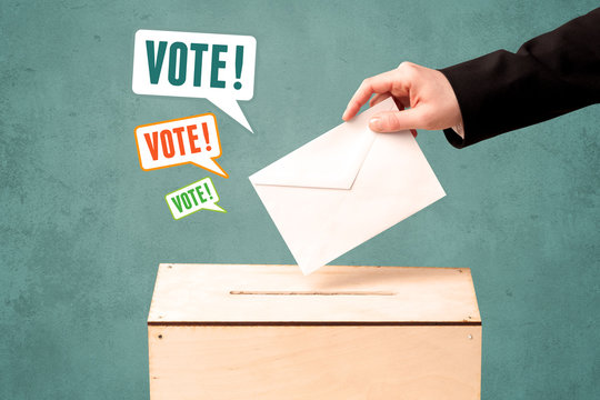 placing a voting slip into a ballot box