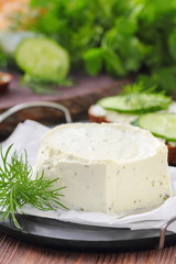 Obraz na płótnie Canvas Delicious soft cheese with greens