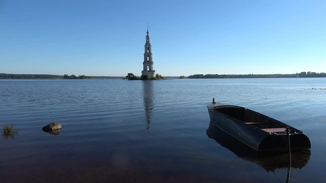 A view of an ancient flooded bell tower. July evening. Kalyazin, Russia