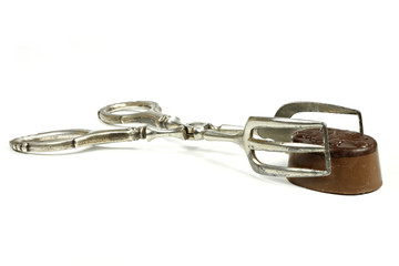 Obraz premium pastry tong with Belgian chocolate praline isolated on white background