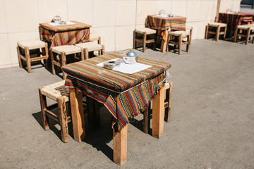 Turkish street street coffees in Istanbul. Wooden tables and chairs stand directly on the street. A distinctive and authentic place to visit by locals.