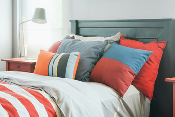 Colorful pillows on bed in modern interior bedroom