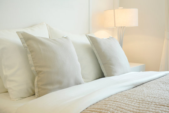 Closeup pillow on bed in warm bedroom modern interior