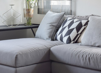 Parallelogram pattern pillow and gray pillows setting on gray so