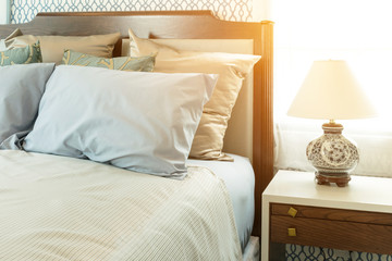 classic style bedroom with blue pillows and chinese lamp style on bedside table