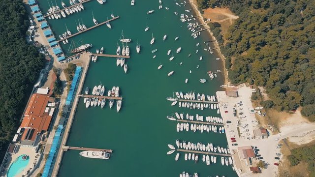 Aerial view of multiple parked motorboats and sailboats at marina piers in Pula, Croatia