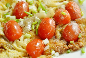 fried egg stuffed Indian mushroom topping slice cherry tomato on plate 