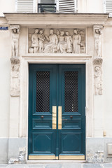 Fototapeta premium Paris, old door with characters sculptured in the girder 