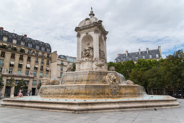 Fototapeta na wymiar Paris, place Saint-Sulpice, the fountain with typical buildings in background 