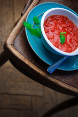 Tomato soup stay on old oriental wooden chair.