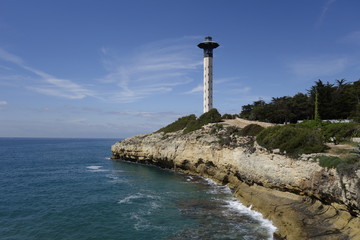 Fototapeta na wymiar Lighthouse in the sea shore