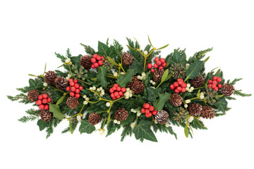 Christmas and winter decoration with holly, ivy, mistletoe, fir and pine cones on white background.