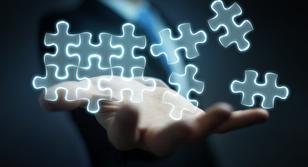 Businessman holding hand-drawn puzzle pieces