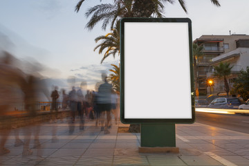 Blank billboard in a footpath at sunset