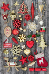 Christmas symbols with bauble decorations on rustic wood background.