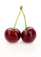 Cherry on a white background with drops of water