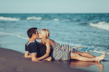 Fototapeta premium Young couple in love walking on the beach