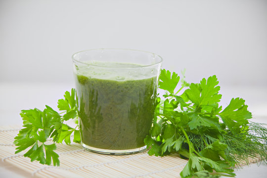 parsley and celery juice in glass on  table