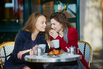 Two young girls in Parisian outdoor cafe