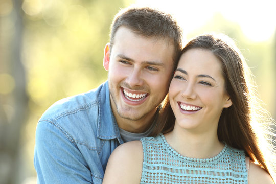 Happy couple with perfect smile looking at side