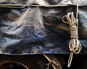 old rope loop and dirty old canvas covered truck on truck for transportation background