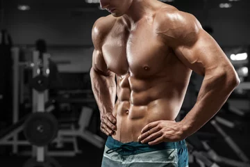 Fotobehang Muscular man abs in gym, shaped abdominal. Strong male naked torso, working out © nikolas_jkd