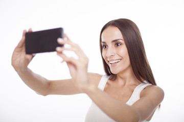 The beautiful girl doing selfie isolated.