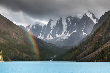 Altai mountains landscape with forest and rainbow