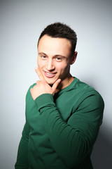 Young handsome man on gray background