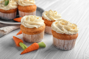 Delicious carrot muffins on wooden table