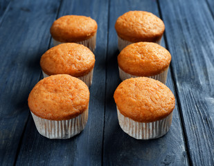 Delicious carrot muffins on wooden background