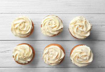 Delicious carrot muffins on wooden background