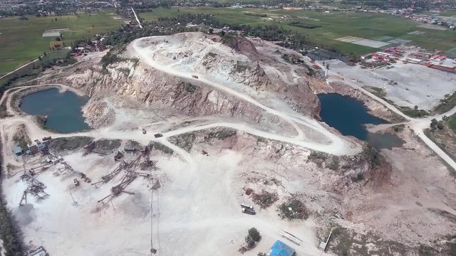 drone view : flying over a stone quarry with dump trucks
