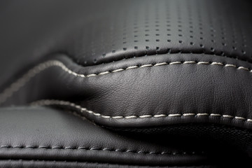 Black leather interior. Close up shot of stitches on a luxury car seat. - 166791476
