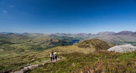 Hikers walking across the Torc Mountain in Killarney National Park, Ireland