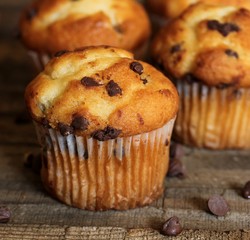 Mini Chocolate chip Muffins on wooden background, selective focus