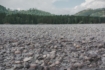 Beautiful stone bank of a mountain river on the Altai